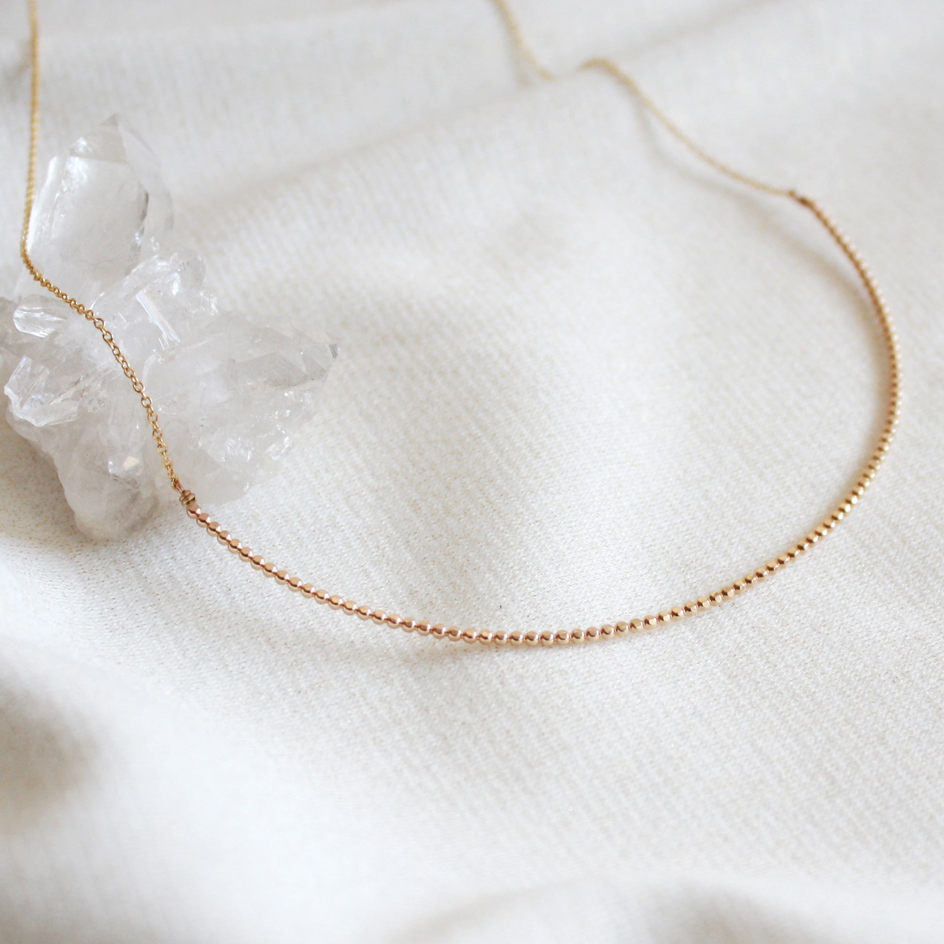 gold beaded arc necklace