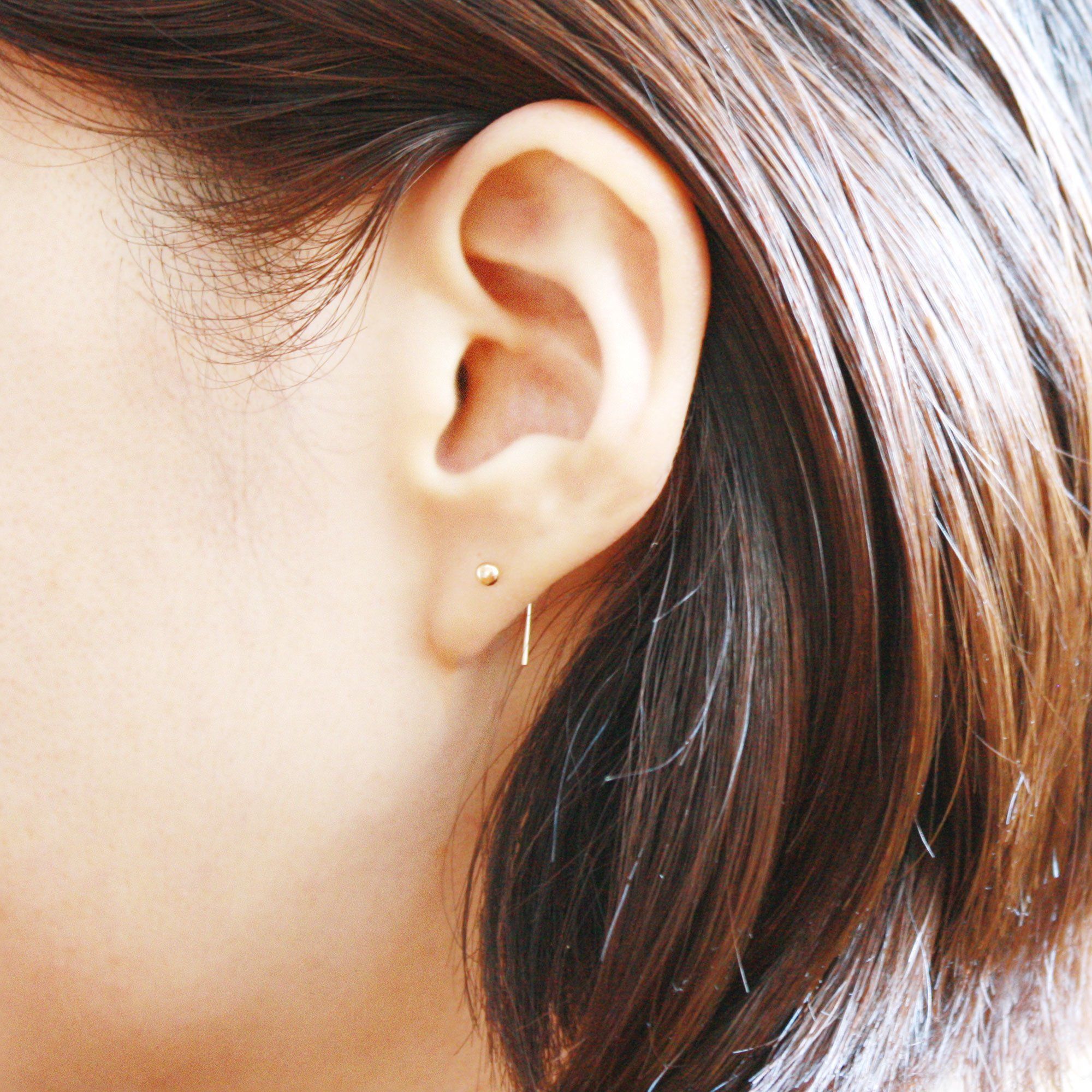 Tiny gold store dot earrings